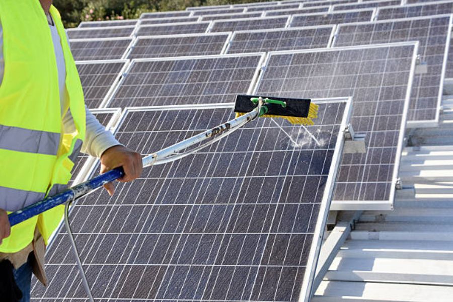 A professional engineer cleaning solar panels.